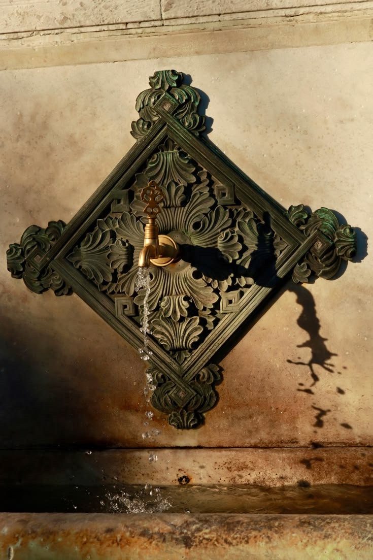 Water flowing from an ornate brass fountain
